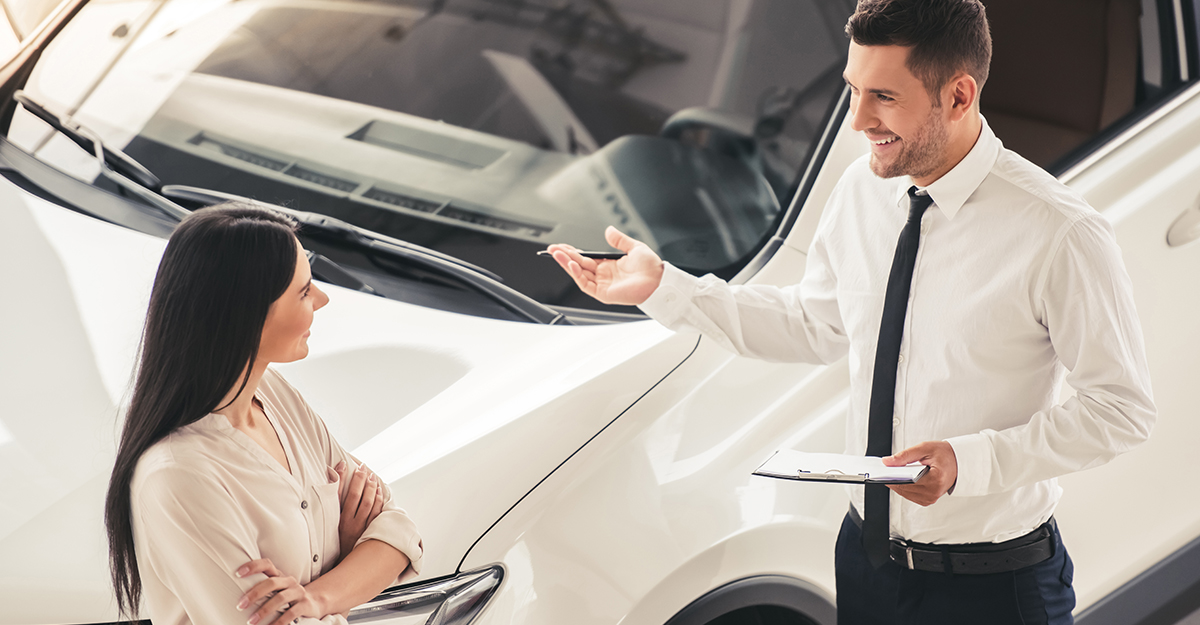 Girl at car dealership