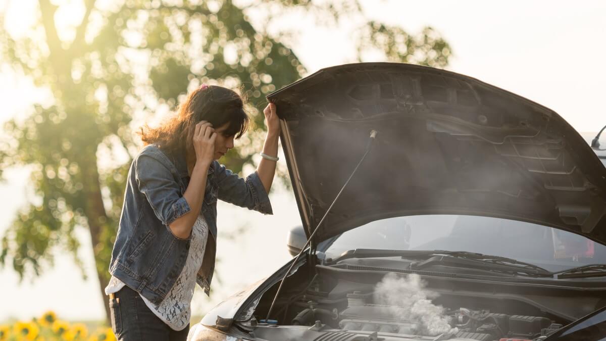 Woman with overheating car