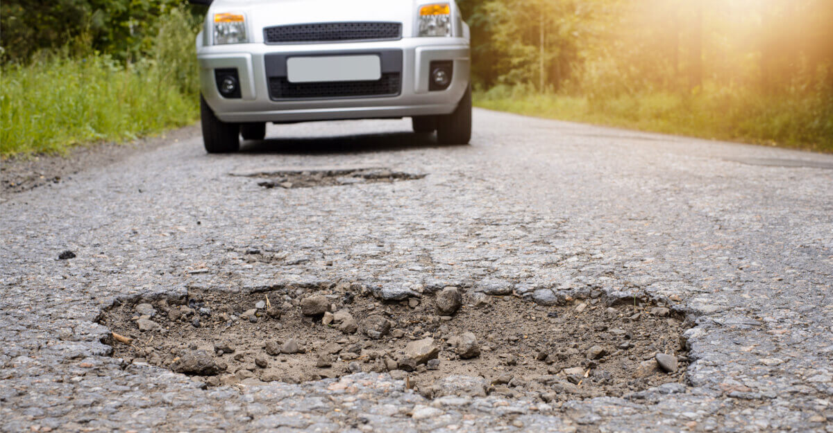 Car approaching pothole