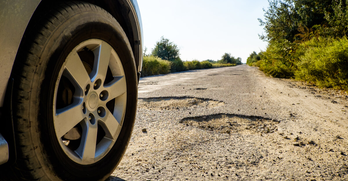 Car approaching potholes